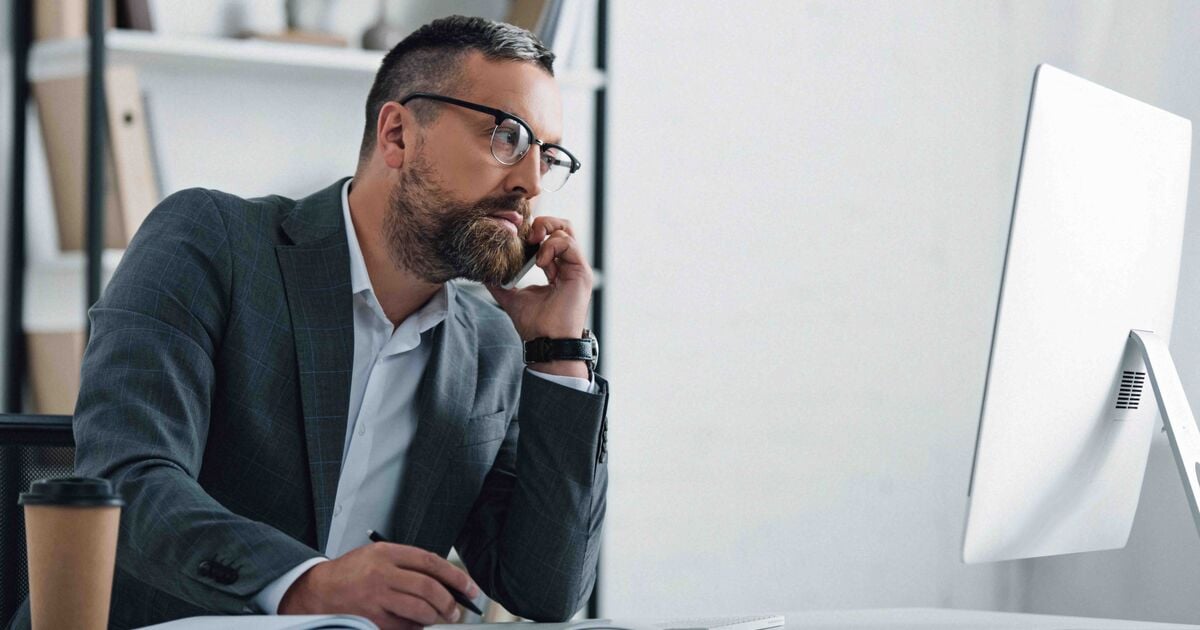 Businessman in formal wear talking on smartphone