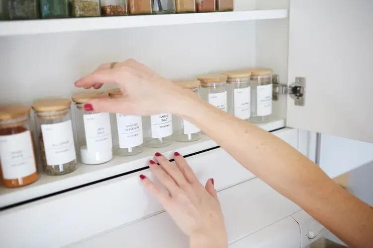 Hand reaching for spice rack