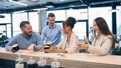 Web_Desktop-Cheerful corporate employees communicating at coffee break