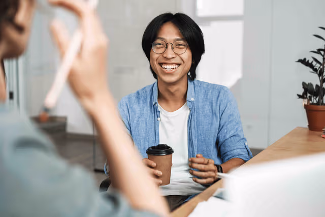 webimage-Image-of-multinational-joyful-colleagues-discussing-project-and-laughing