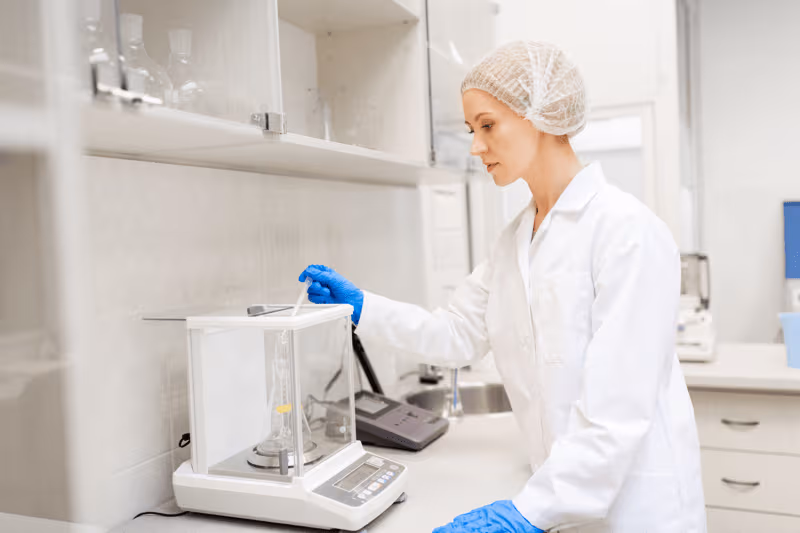 webimage-woman-with-sulphuric-acid-and-scale-at-laboratory